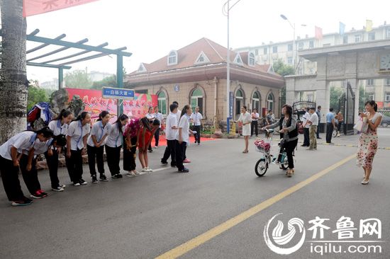 学生们一大早在学校门口迎接老师并送上节日的祝福。