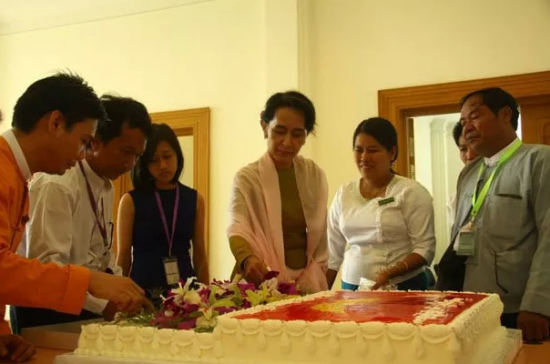 图为庆祝69岁生日的昂山素季在切生日蛋糕。