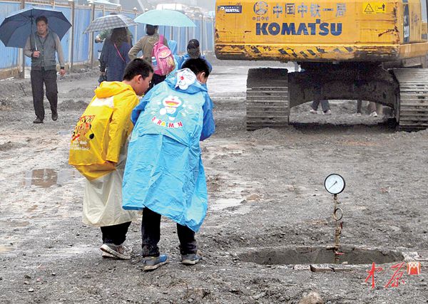 昨日下午，文化路俭学街交叉口北侧的施工围挡区域内，两个孩子在尚未竣工的窨井前好奇地观望。郑州晚报记者 周甬 图