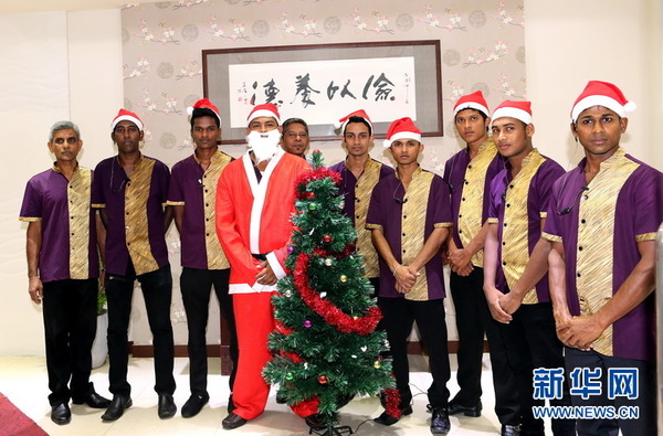 唐朝食府圣诞老人及服务人员在门口列队迎客.(新华网记者 黄海敏 摄)