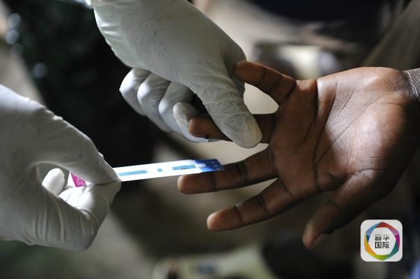 11月10日，肯尼亚西部霍马贝，公共卫生所的工作人员为病人做艾滋病病毒筛查。（图片来源：新华／法新）