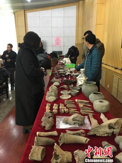 图为考古专家研究本年度出土的西土城考古成果　刘洋　摄