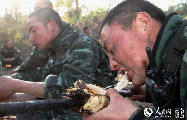 3月25日，武警特战队员连续奔袭两昼夜，终于吃上自己烧烤的美味佳肴。（摄影：李彬彬）
