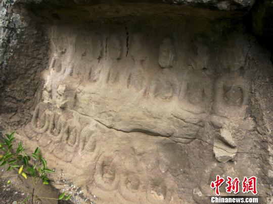 摩崖石刻的部分佛像头部已破损　张帆　摄