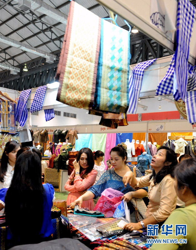 11月3日，在老挝首都万象，市民在展会上购买老挝传统服饰。