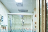 蓝色墙面瓷砖与淡粉色瓷砖拼接，使这个以天蓝色为主色调的卫浴空间显得尤为清新，狭长形的小户型卫生间中总少不了一个玻璃淋浴房，实用且不影响整体空间感。（实习编辑：温存）
