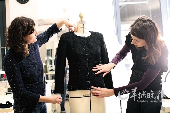 外套拼制过程中，裁缝师仔细地检查外套的比例