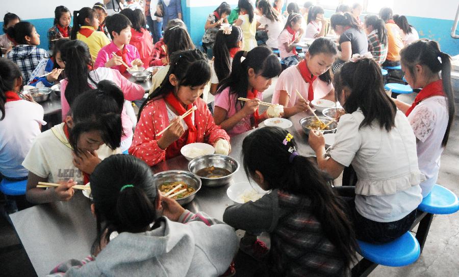 7月3日，黑龙江省绥化市青冈县连丰乡中心小学的学生们在食堂吃营养午餐。新华社记者 王凯 摄
