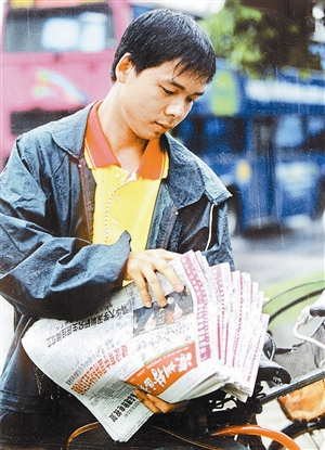 本报发行公司投递员冒雨为订户送报. 深圳特区报原记者 许光明 摄